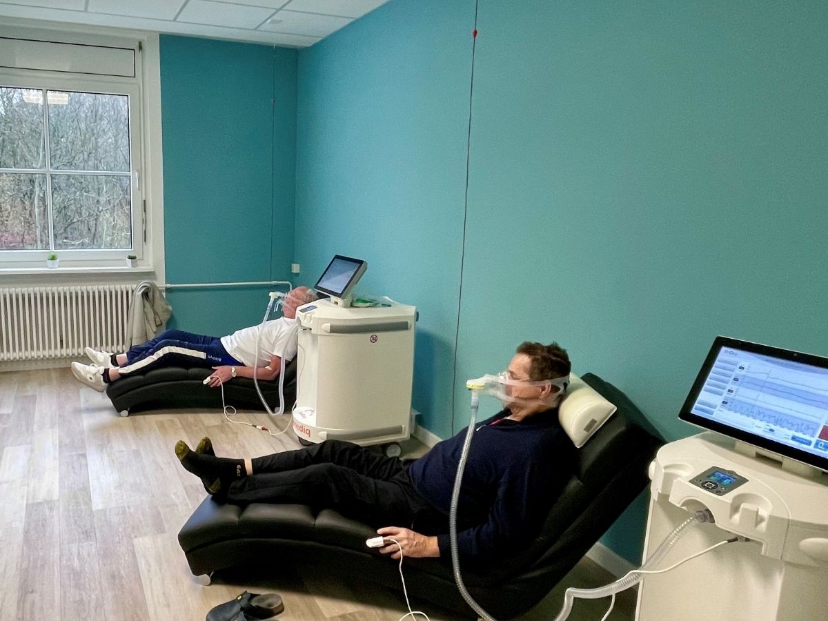 Zwei Personen tragen eine Atmungsmaske und machen eine Intermittierende Hypoxie-Hyperoxy-Therapie (ReOxy)