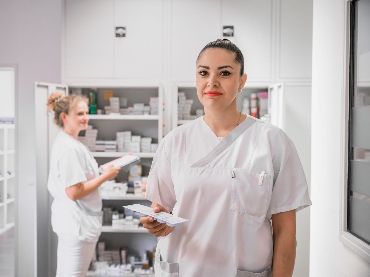 Die Schwester hat eine weiße Arbeitskleidung an