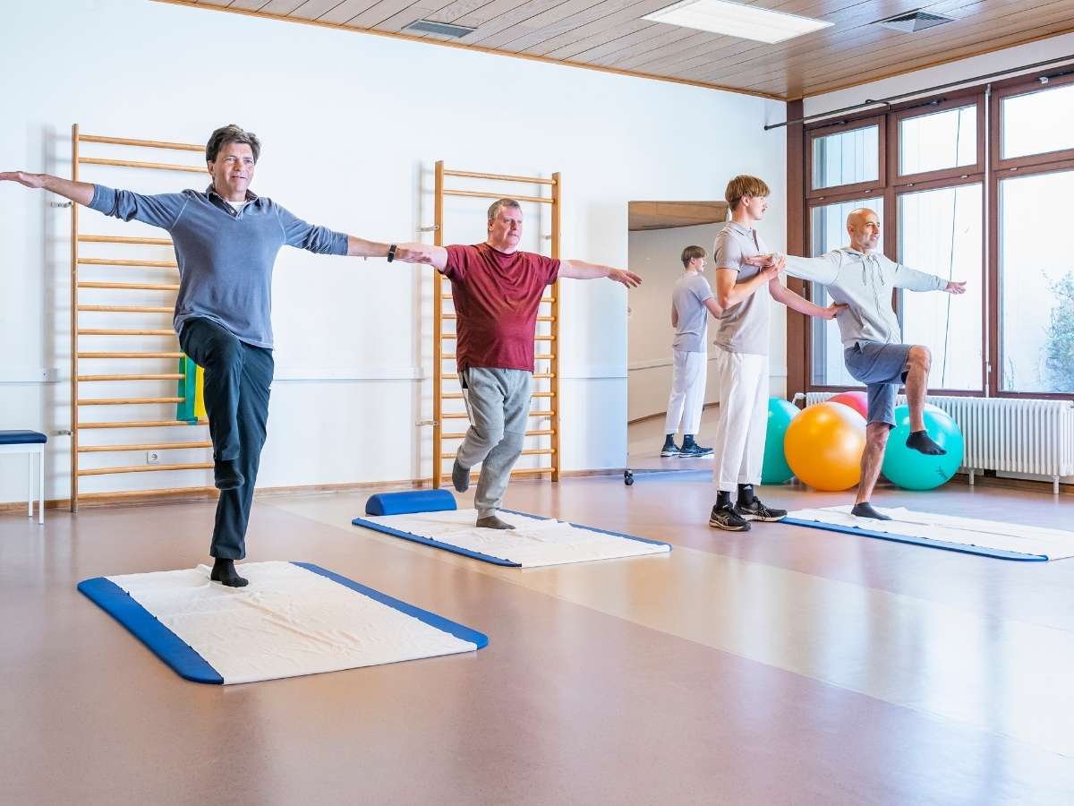 Die Personen führen eine Übung durch im Rahmen des Therapieablaufs mithilfe ärztlicher Betreuung 