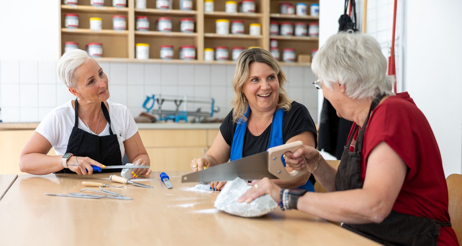 Drei Frauen die sich unterhalten und mit Steinen arbeiten 