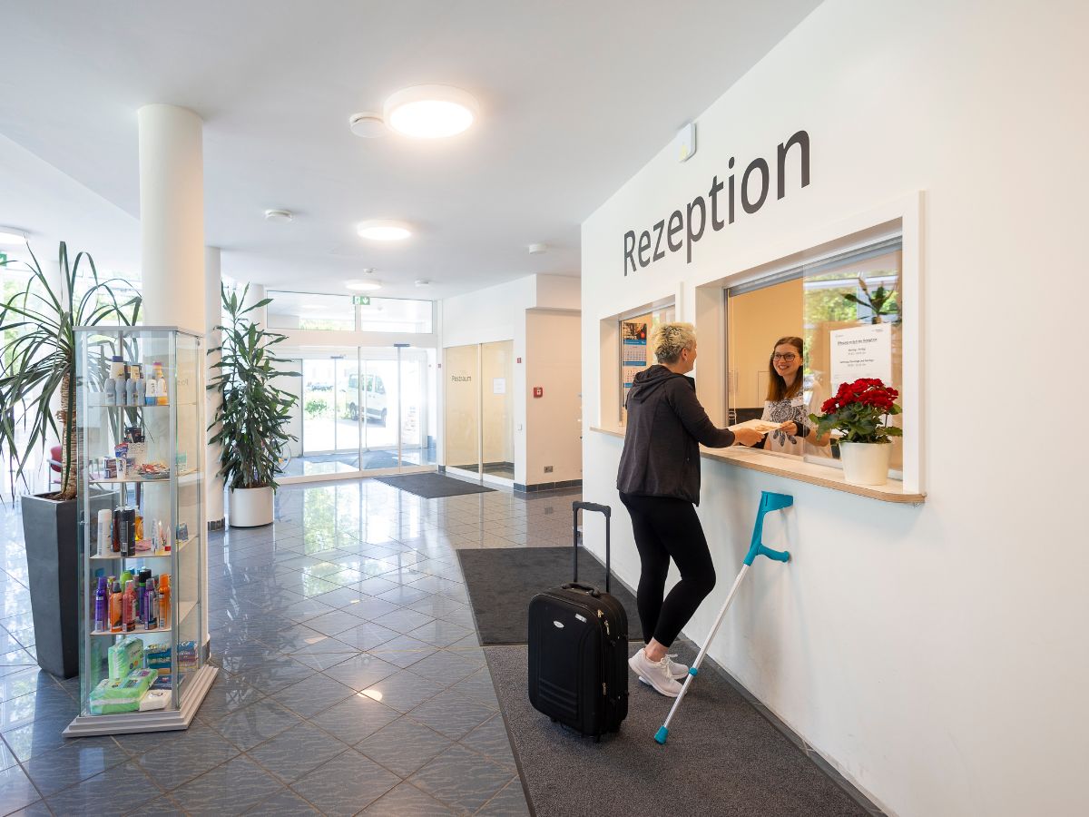 Eine Patientin die an der Rezeption eincheckt 